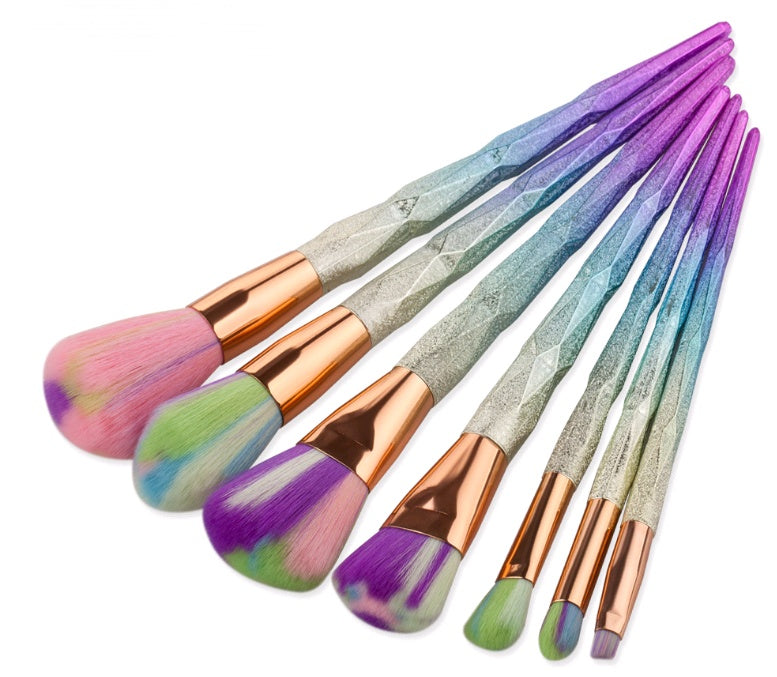Set of makeup brushes with gradient handles on a white background